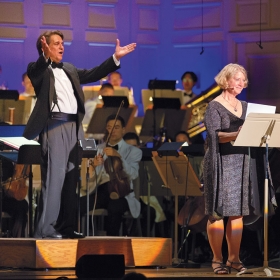 A photo shows Keith Lockhart, conductor of the Boston Pops, with astronaut Pam Melroy '83, during a concert celebrating the anniversary of the moon landing in 1969.