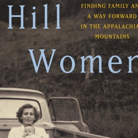 The cover of Hill Women shows black-and-white photo of a mother standing by a pickup truck holding a baby while a young boy stands alongside.