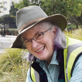 A photo of Jennie Gerard '66 working in the landscape around Lake Merritt in Oakland, Calif.