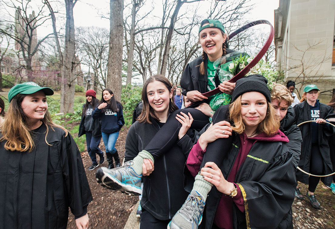 Laurel Willis ’17 is carried to Lake Waban on the shoulders of her Shakespeare Society friends