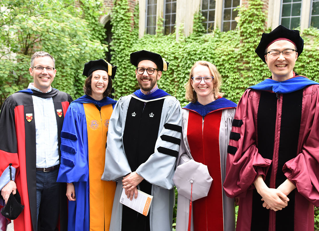 A photo of five faculty members in their full academic regalia,