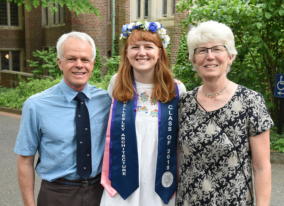 A photo of a graduate flanked by her proud parents.