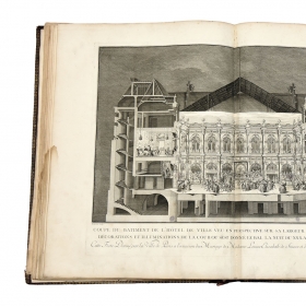 A photo shows a cross-section illustration of French aristocrats dancing at a wedding. The 18th-century festival book measures 25 inches high and 37 ½ inches across when open..