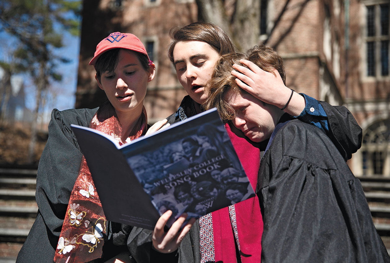 Students sing College songs and hug each other