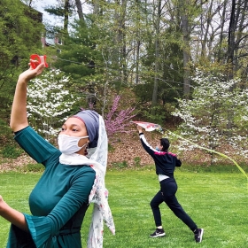A. photo shows Muslim students flying kites while celebrating Eid on campus in spring 2021. 
