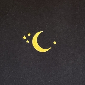 Cover of Grace Ramsdell's diary; a black notebook with a yellow crescent moon and four stars
