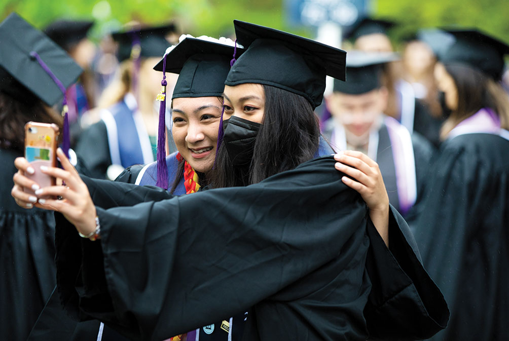Two students take a selfie after the ceremony.