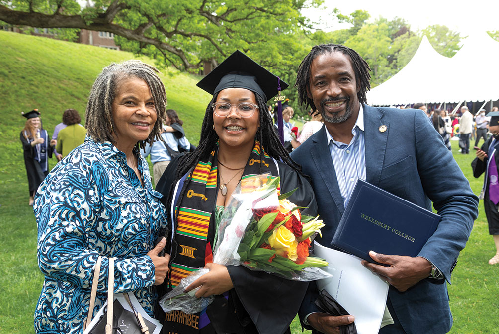 A graduate celebrates with family.