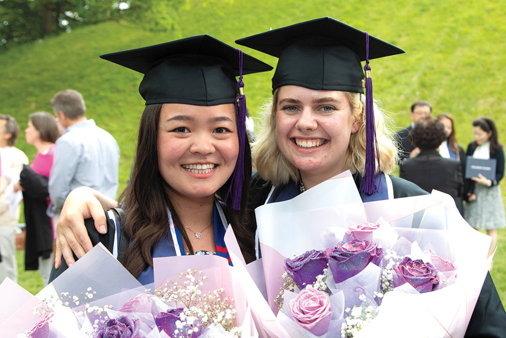 Two members of the purple class hold flowers. 
