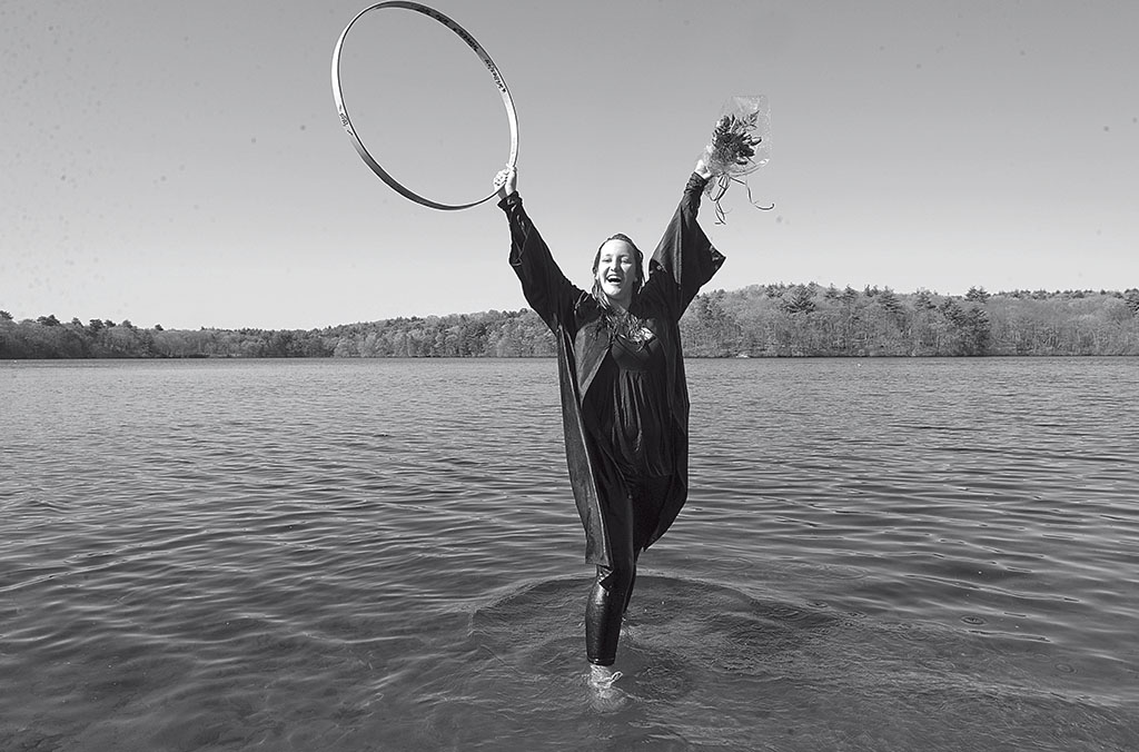 The winner of the 2010 race stands in Lake Waban.