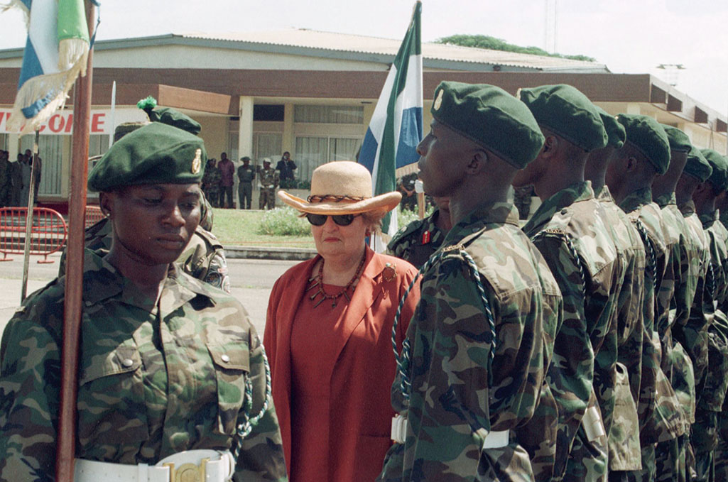 A photo shows Albright reviewing a Sierra Leonean honor guard at the airport of Lungias on Oct. 18, 1999.