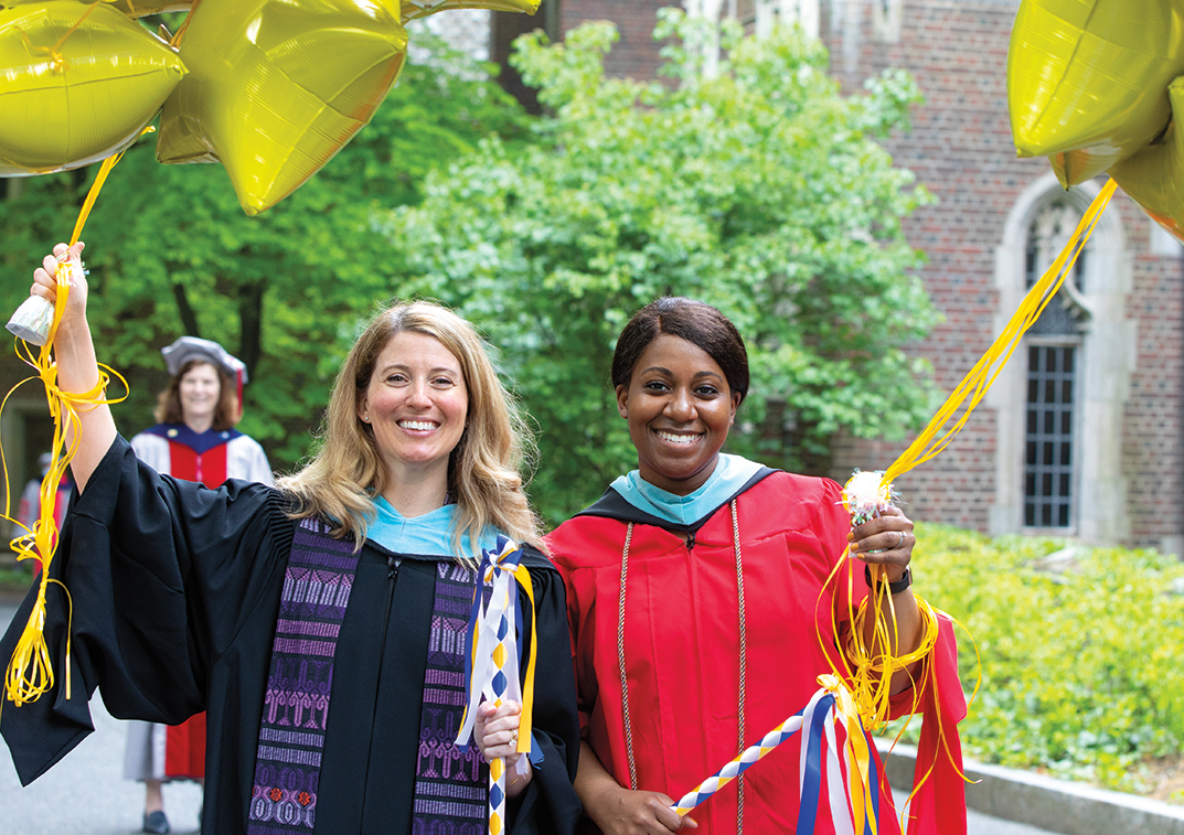 Faculty members in academic robes celebrate the yellow class of '23.