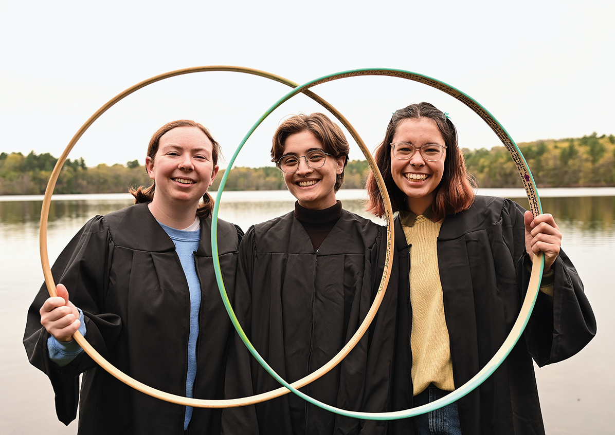 Three seniors show off their hoops by Lake Waban.