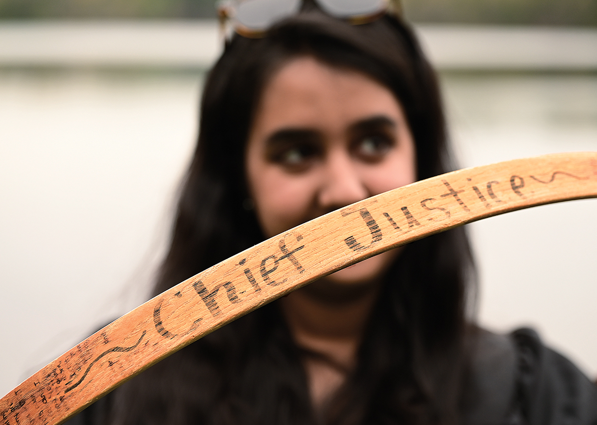 A senior displays the signtaures of previous students on her hoop.