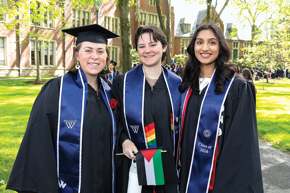 Three graduates pose after the cremony