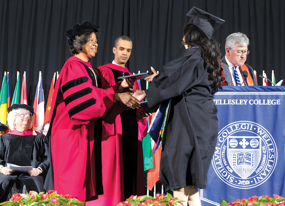 President Paula Johnson presents a diploma.