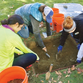 Students dig by the site of College Hall.