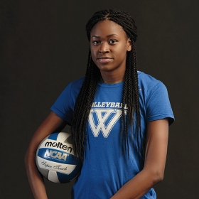 Portrait of Yasmine Reece ’19 in her volleyball uniform, holding a volleyball.
