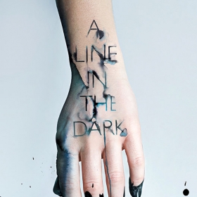 The cover of Malinda Lo's novel. A Line in the Dark, shows a photograph of a hand with dark ink dripping off the fingers.