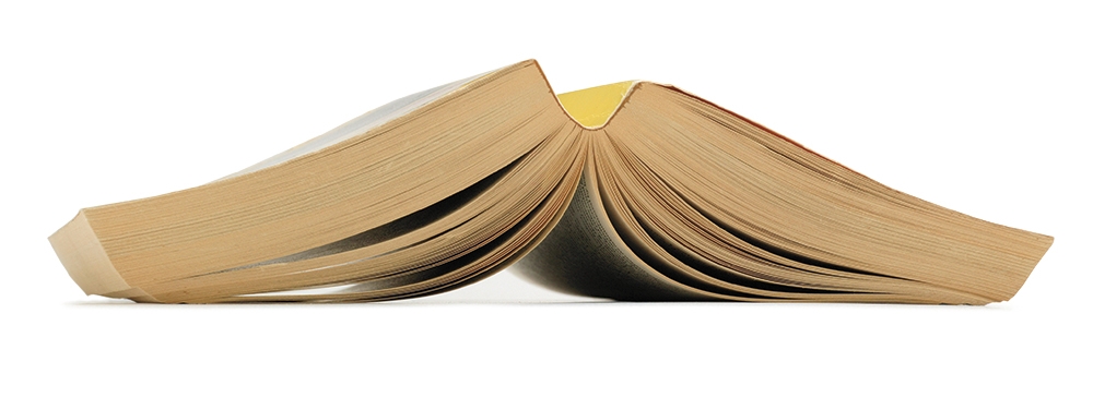 A photo shows an open paperback book, splayed face down.
