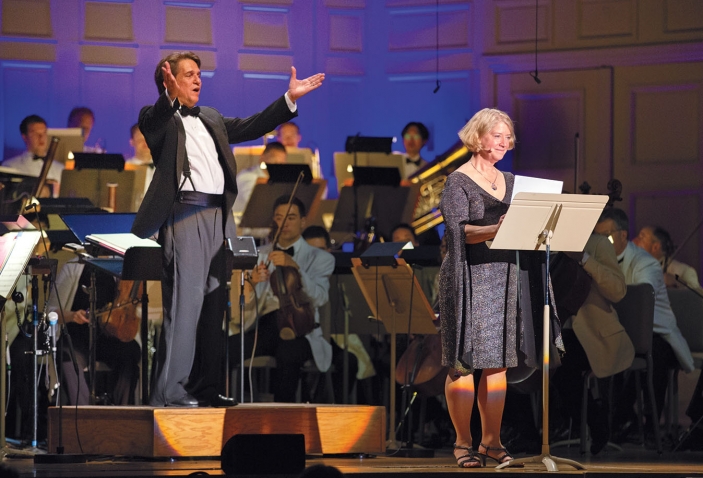A photo shows Keith Lockhart, conductor of the Boston Pops, with astronaut Pam Melroy '83, during a concert celebrating the anniversary of the moon landing in 1969.