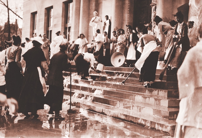 Wellesley seniors scrub the library steps during a May Day celebration after the College Hall fire, date unknown.
