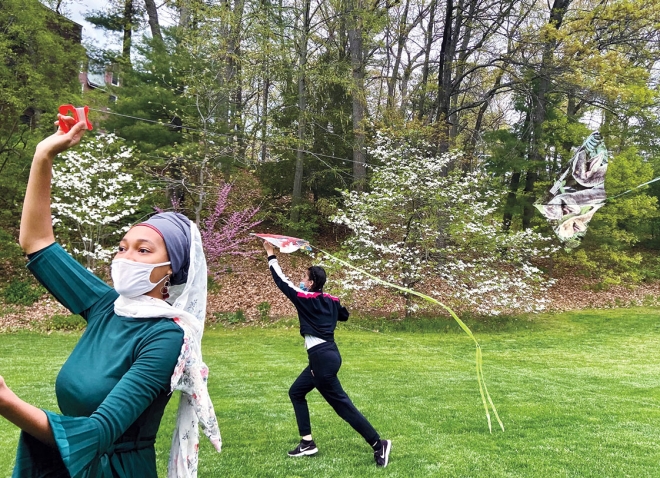 A. photo shows Muslim students flying kites while celebrating Eid on campus in spring 2021. 