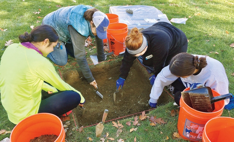 Students dig by the site of College Hall.