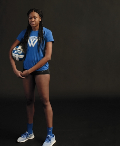 Portrait of Yasmine Reece ’19 in her volleyball uniform, holding a volleyball.