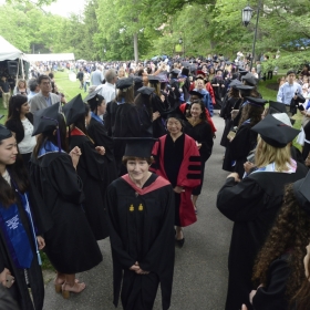 A photo of the faculty procession nearing the tent on Commencement day