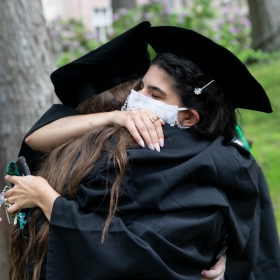 Students embrace at commencement