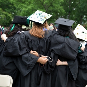 Graduates embrace after commencement