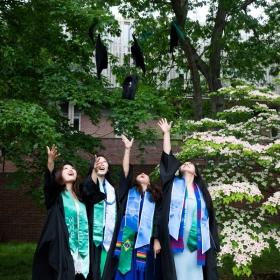 Students toss their tams after commencement