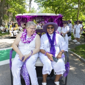 Two members of the class of 1979 in a golf cart in the parade