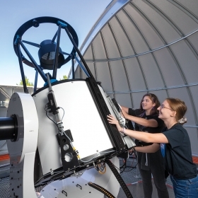 Students adjust the position of the new telescope