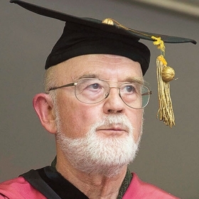 A photo shows Professor Philip Kohl in his academic regalia