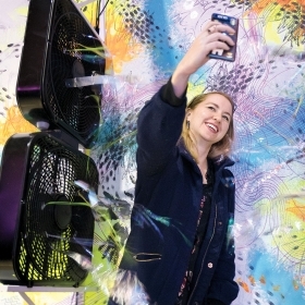 A member of the Austin Wellesley Club uses her phone to snap a selfie during a tour of artists' studios the club enjoyed.
