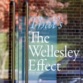 Photo of window with "That's The Wellesley Effect" sign posted in it