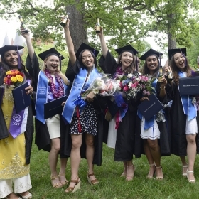 A photo of six new alumnae from the class of 2018 celebrate after the ceremony.