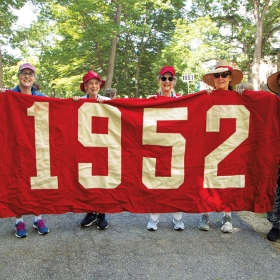 Members of the class of 1952 hold their banner