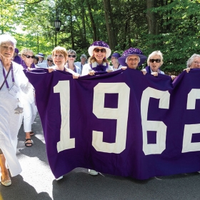 Members of the purple class of 1962 pose with their banner