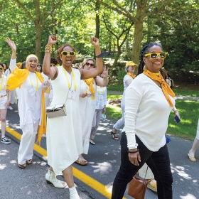 A yellow class marches in the alumnae parade