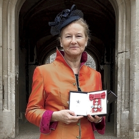 A photo of Kathryn Bishop holding her Order of the British Empire medal