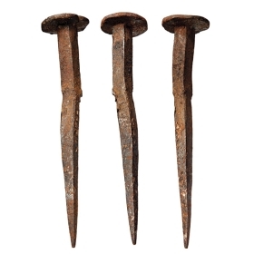 A photograph of three antique nails