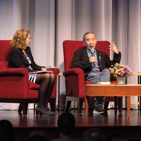 Eve Zimmerman, Haruki Murakami, and Koichi Hagimoto, associate professor of Spanish, on stage in Alumnae Hall.