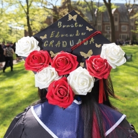A photo of a graduate's mortar board decorated with roses