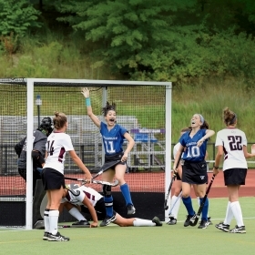 A photo shows Arielle Mitropoulos ’19 (#11) and Julia Rappaport ’22 (#10) jumping for joy as Sophia Albanese ’21 (#24) scores her first collegiate goal in a 5–0 win over the University of Maine at Farmington this past September.