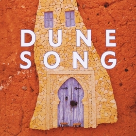 The cover of Dune Song by Anissa Bouziane depicts the closed door of a Moroccan house.