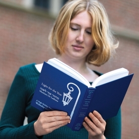 A photo of a student holding the recently published Wellesley Passover prayer book