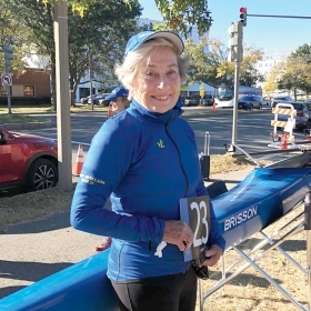 A photo of Peggy Cullen Nicholson '54 beside a racing scull.